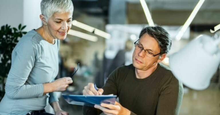 merverdiavgift moms og mva - to personer som ser på en tablet